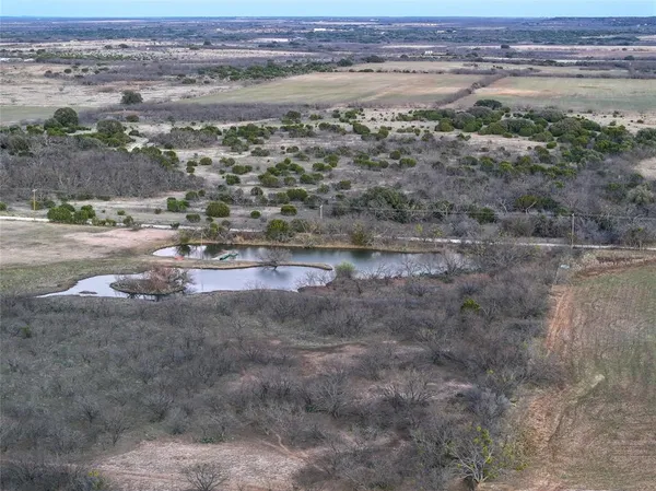 a view of car parked on road with trees