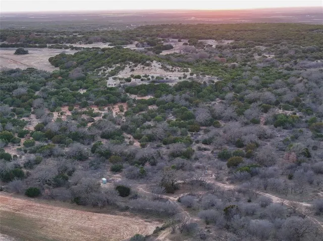 an aerial view of residential houses with outdoor space and ocean view