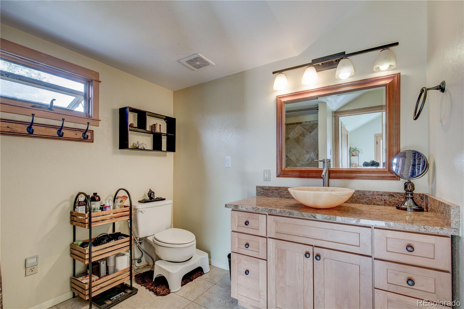 136 Elk Ridge Lane Boulder, CO 80302 - Photo 13 of 27 a bathroom with a granite countertop sink mirror and toilet