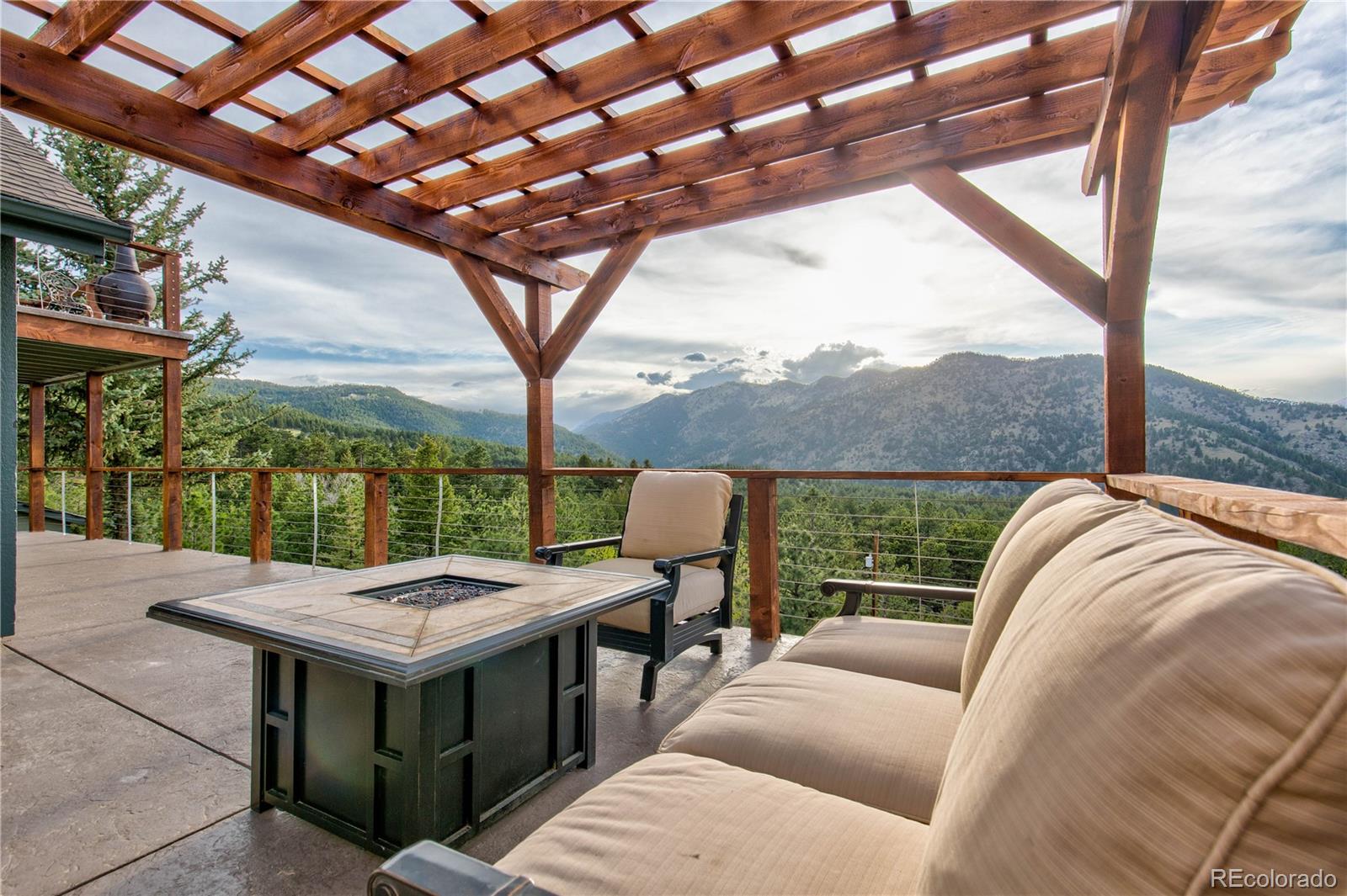 136 Elk Ridge Lane Boulder, CO 80302 - Photo 2 of 27 a view of a terrace with couches and wooden fence