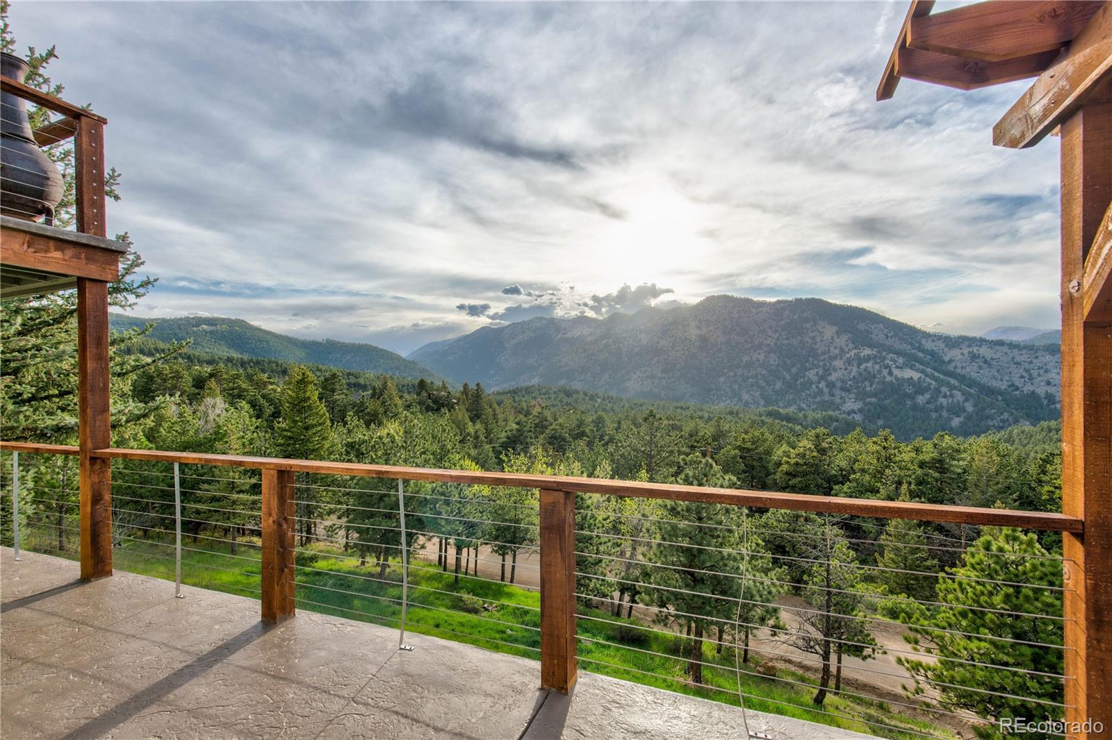 136 Elk Ridge Lane Boulder, CO 80302 - Photo 4 of 27 a view of a balcony with a forest