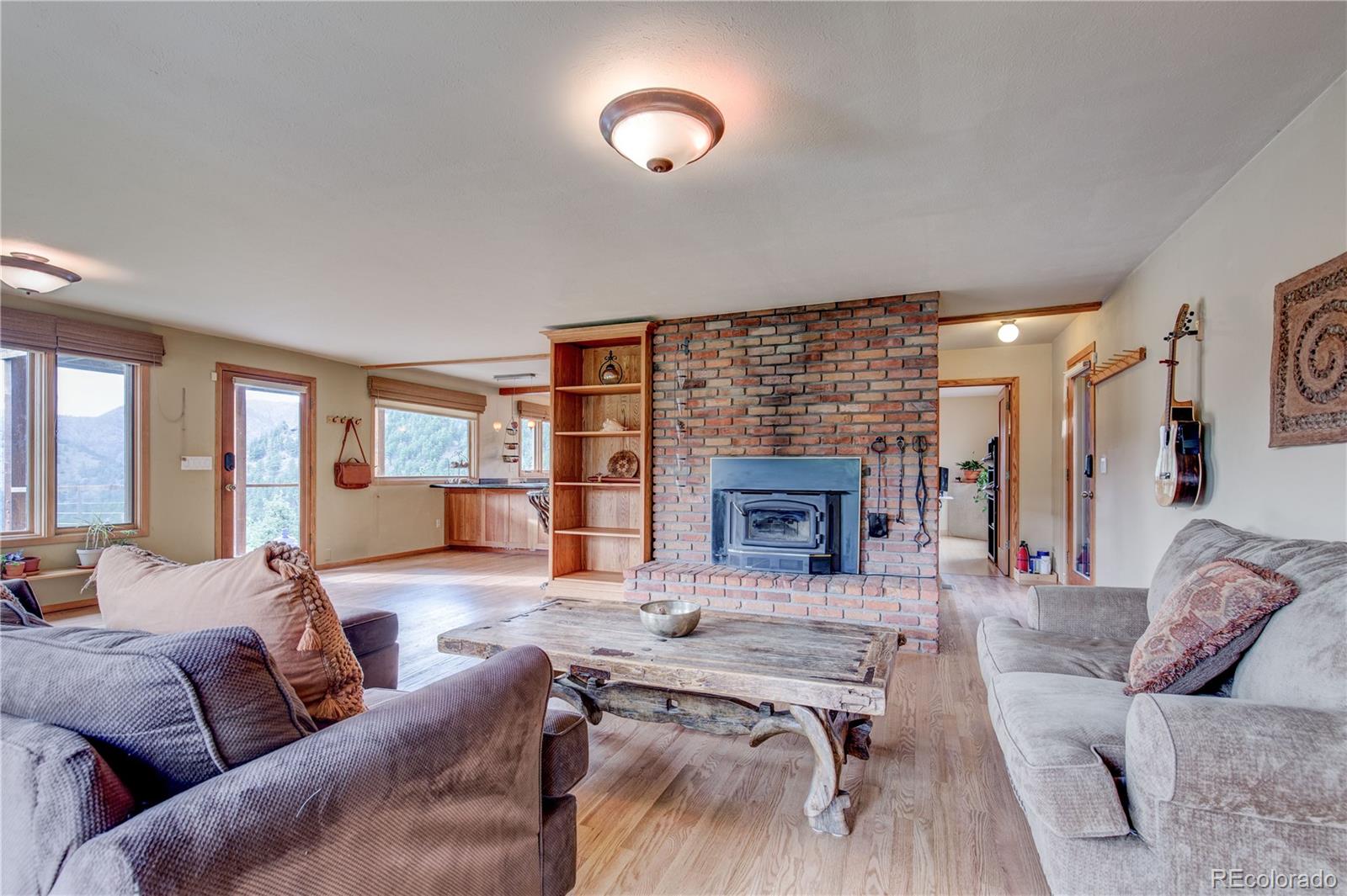 136 Elk Ridge Lane Boulder, CO 80302 - Photo 9 of 27 a living room with furniture and a fireplace