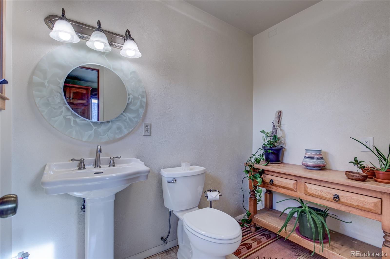 136 Elk Ridge Lane Boulder, CO 80302 - Photo 10 of 27 a bathroom with a toilet a sink and a mirror