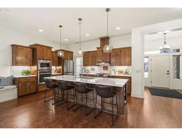 a open kitchen with granite countertop a table and chairs in it