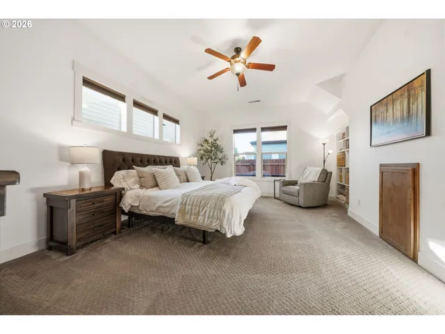 a bedroom with a bed and ceiling fan