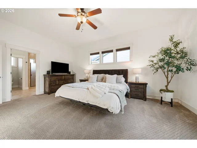 a spacious bedroom with a bed and a chandelier