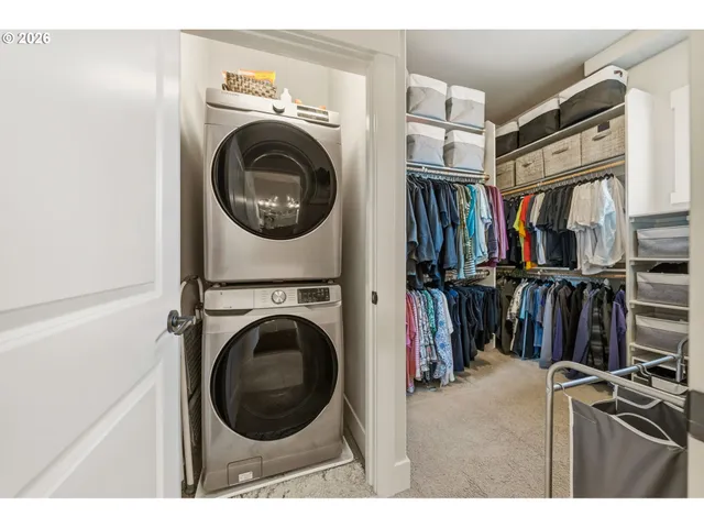a view of a storage and utility room with washer and dryer