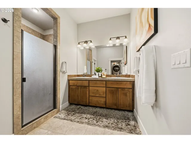 a bathroom with a sink a mirror and a shower