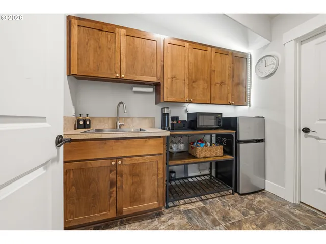 a kitchen with stainless steel appliances granite countertop a refrigerator sink and cabinets
