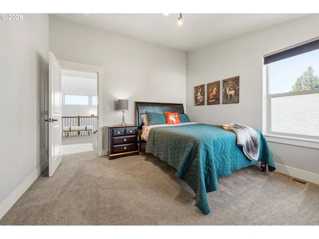 a bedroom with a bed and a large mirror