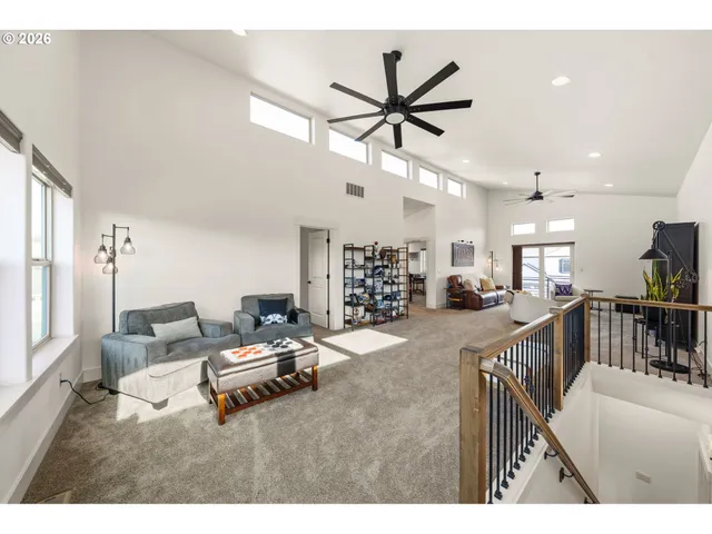 a living room with furniture and a view of kitchen