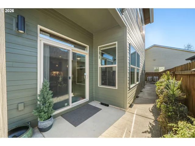 a house with potted plants in front of door