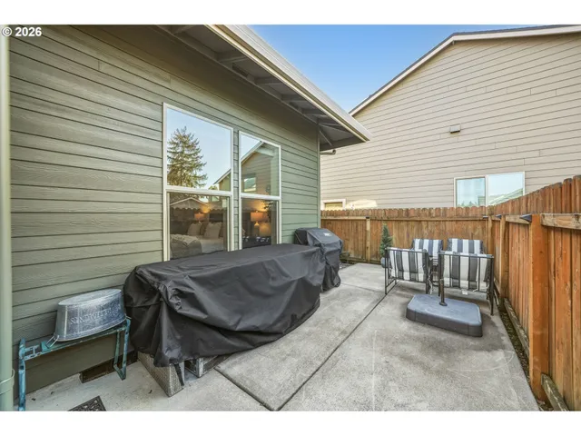 a balcony with table and chairs
