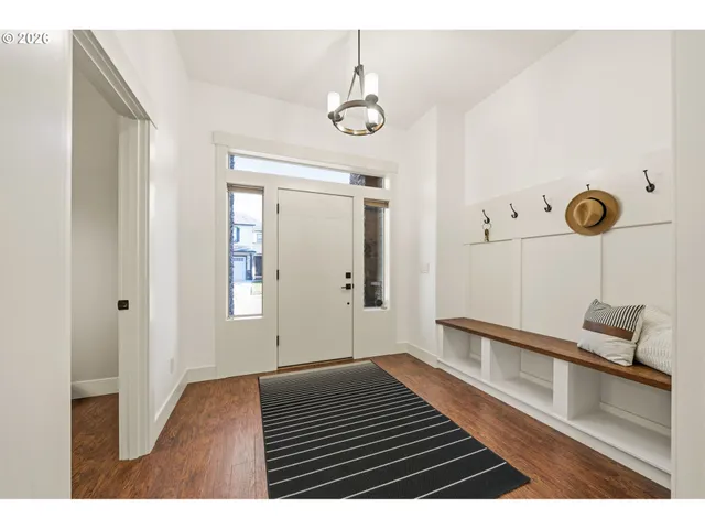 a view of an entryway with wooden floor