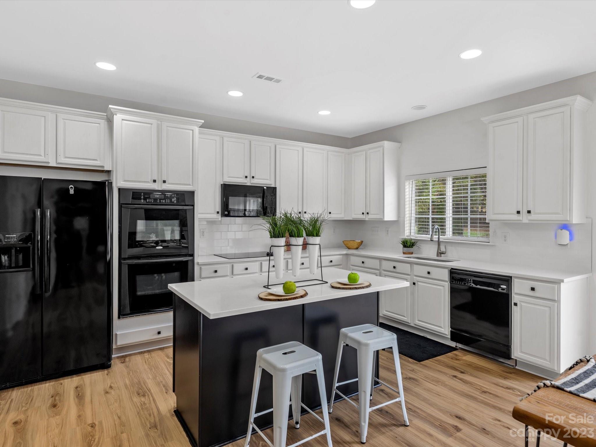 9300 Seamill Road Charlotte, NC 28278 - Photo 12 of 28 a kitchen with white cabinets stainless steel appliances and sink