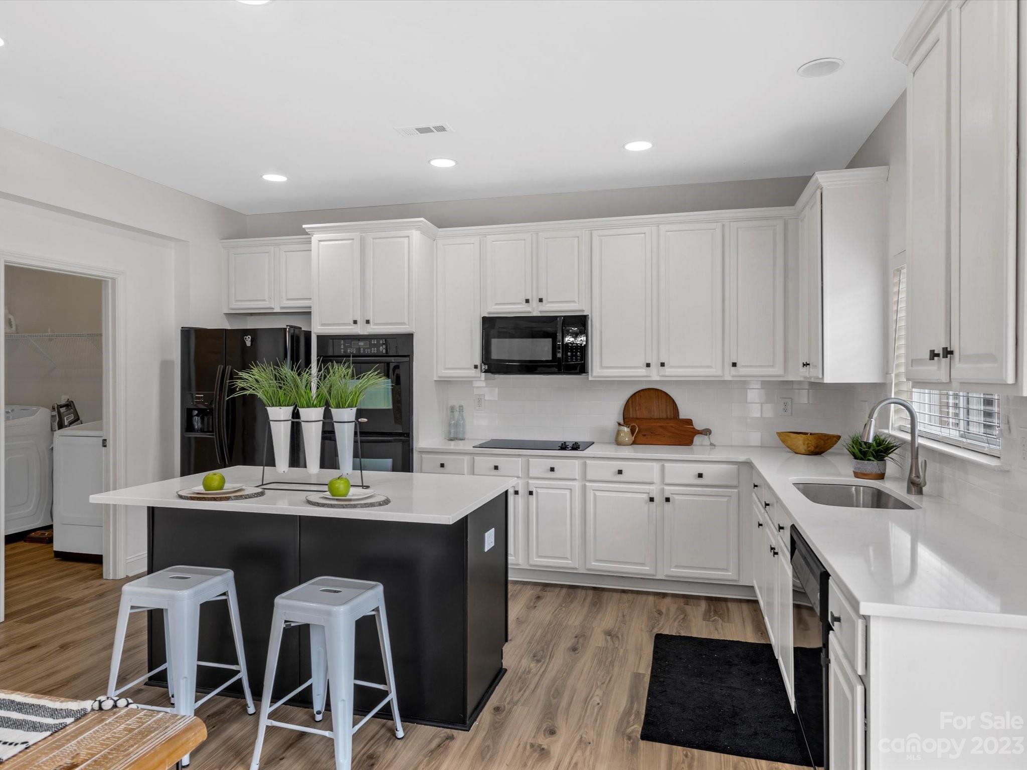 9300 Seamill Road Charlotte, NC 28278 - Photo 13 of 28 a kitchen with stainless steel appliances granite countertop a stove top oven a sink a stove a dining table and chairs