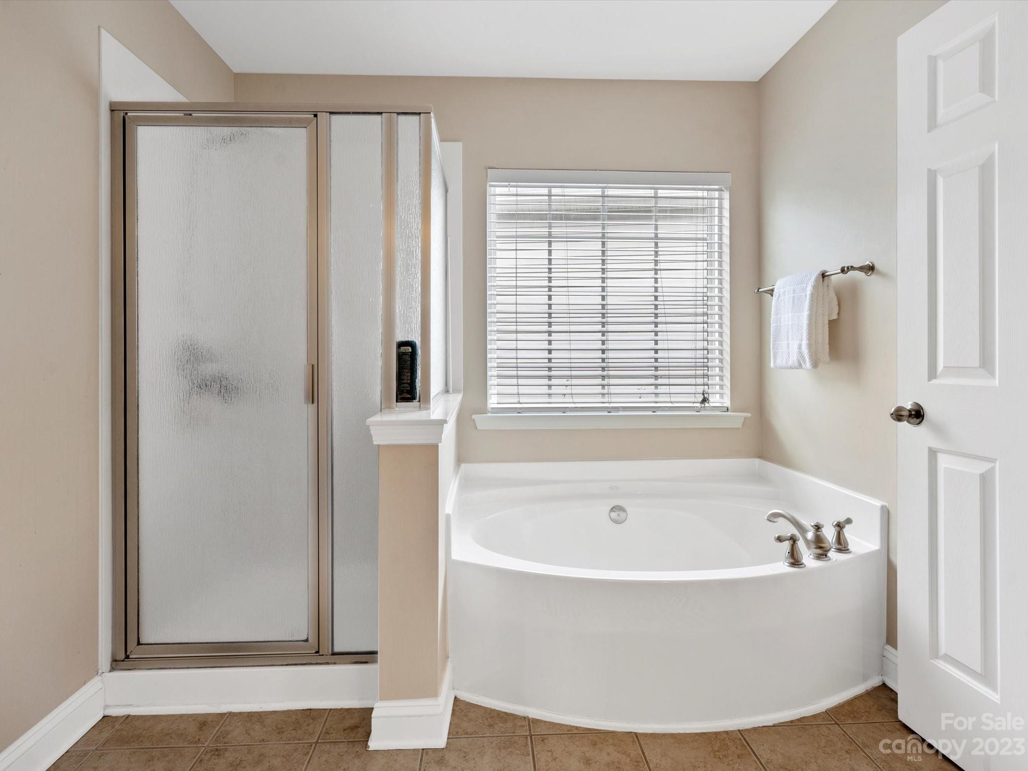 9300 Seamill Road Charlotte, NC 28278 - Photo 20 of 28 a white bath tub sitting in a bathroom