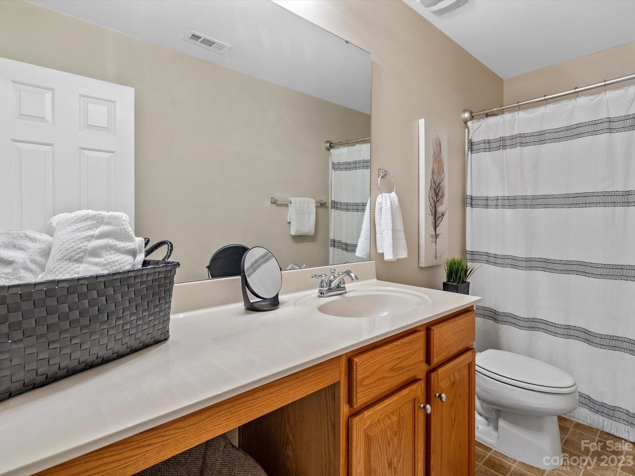 9300 Seamill Road Charlotte, NC 28278 - Photo 24 of 28 a bathroom with a granite countertop sink and a mirror