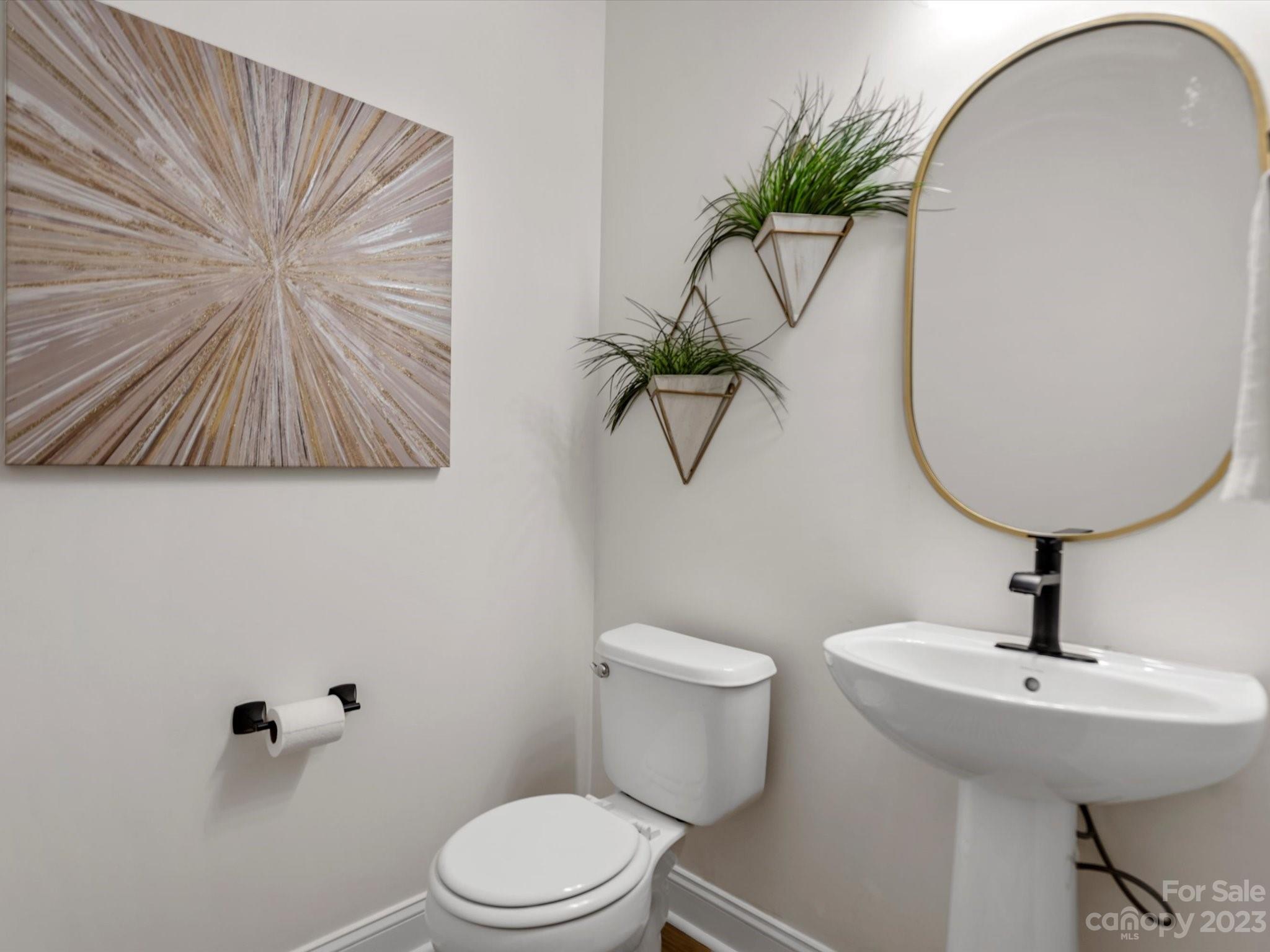 9300 Seamill Road Charlotte, NC 28278 - Photo 5 of 28 a bathroom with a toilet sink and mirror