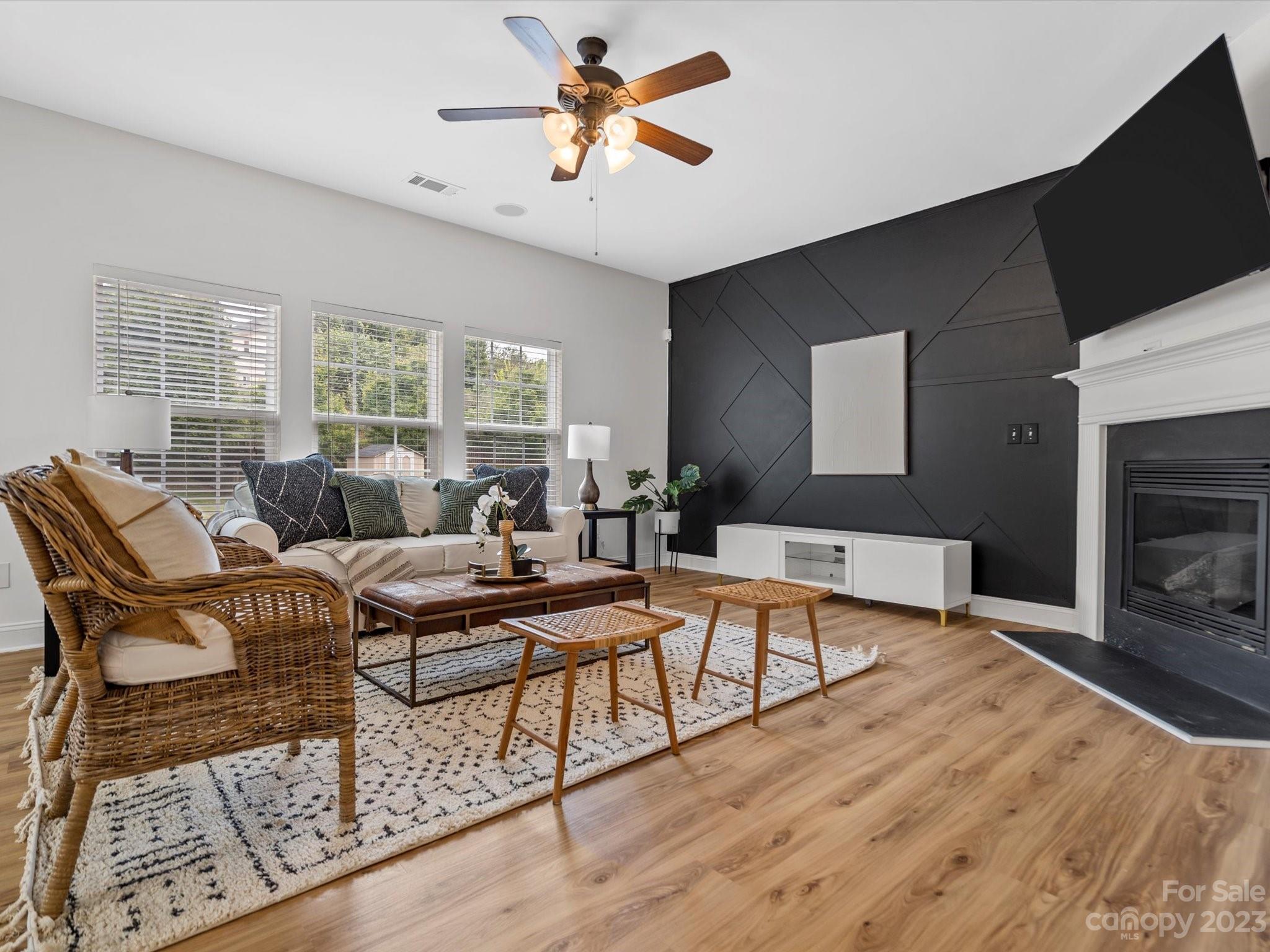 9300 Seamill Road Charlotte, NC 28278 - Photo 6 of 28 a living room with furniture a fireplace and a flat screen tv