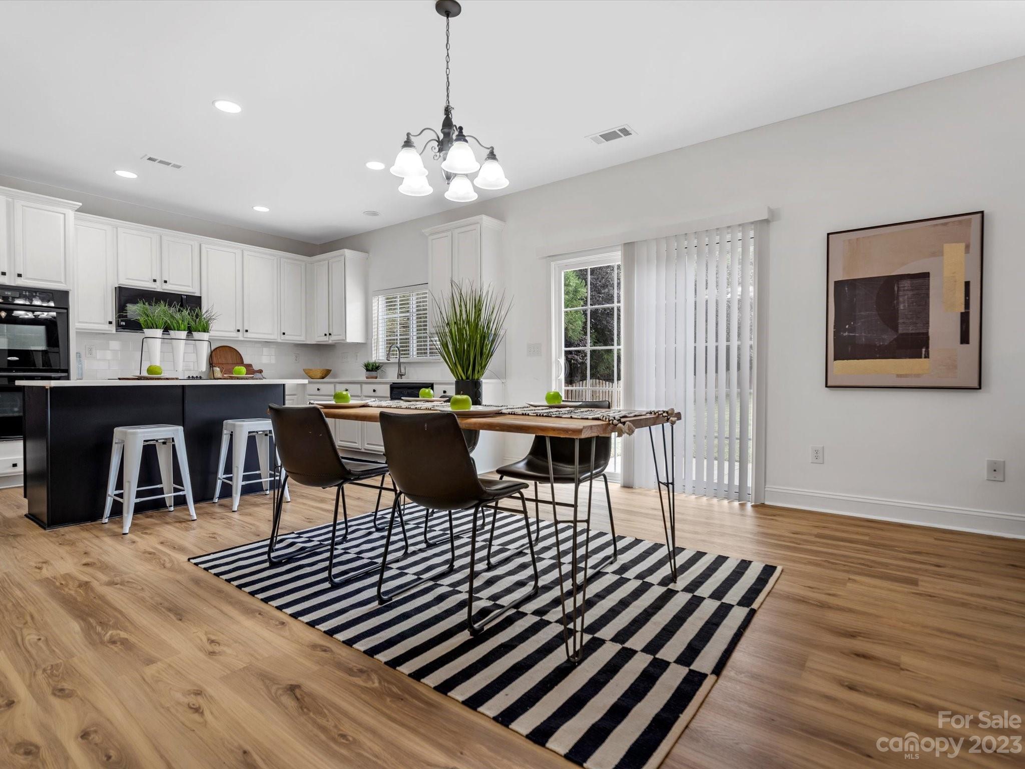 9300 Seamill Road Charlotte, NC 28278 - Photo 10 of 28 a view of a dining room with furniture a rug and wooden floor