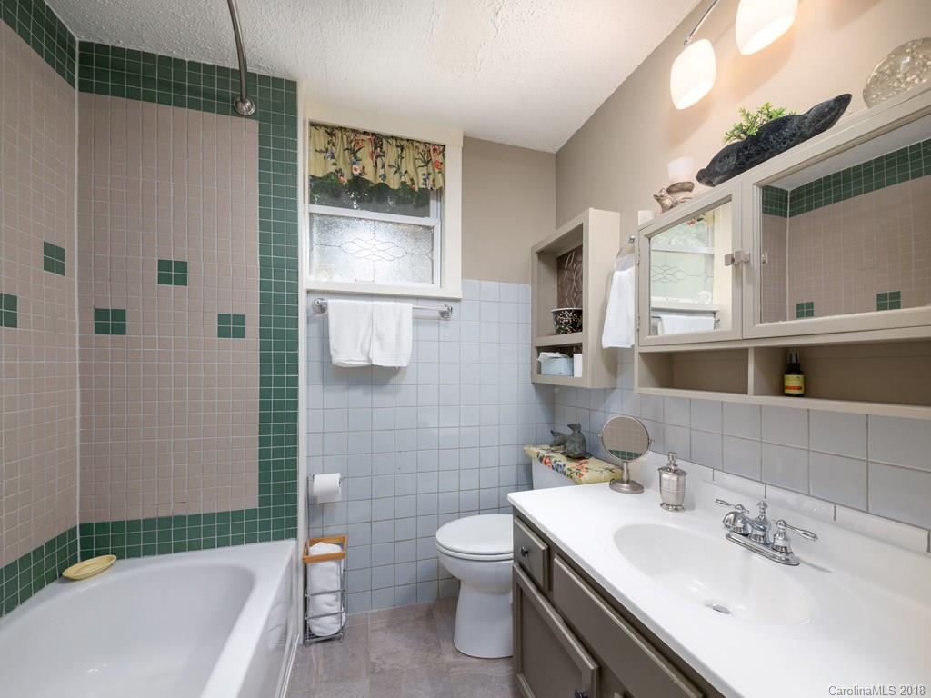 36 Sayles Road Asheville, NC 28803 - Photo 11 of 26 a bathroom with a sink a toilet and shower