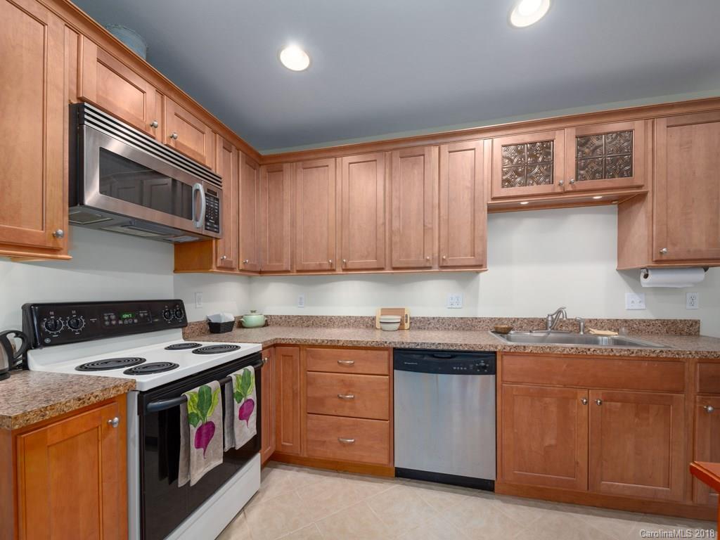 36 Sayles Road Asheville, NC 28803 - Photo 14 of 26 a kitchen with stainless steel appliances granite countertop a stove a sink and a microwave