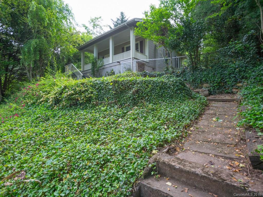36 Sayles Road Asheville, NC 28803 - Photo 18 of 26 a backyard of a house with lots of green space