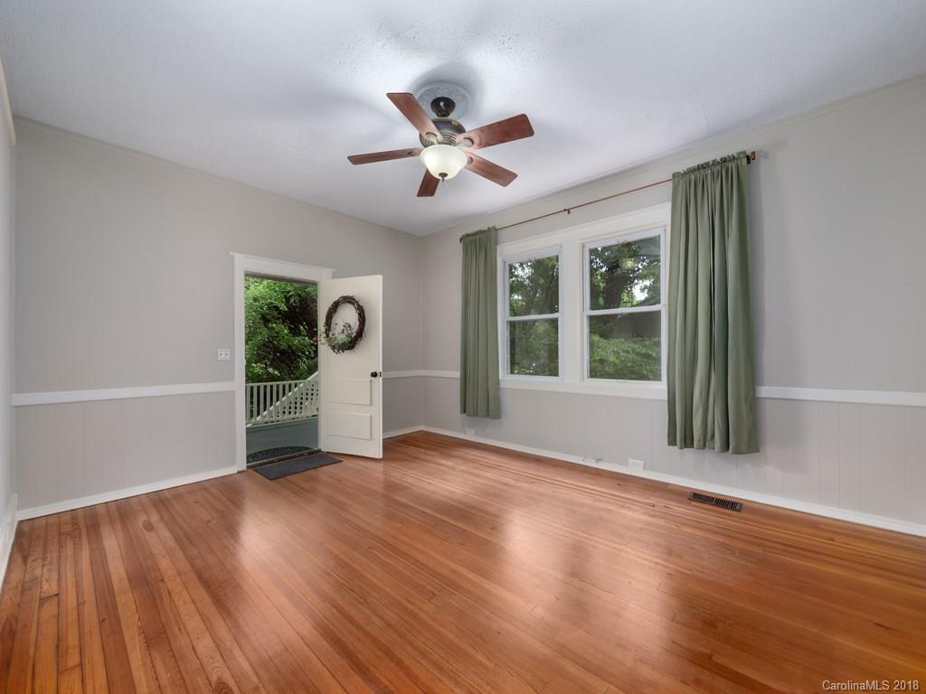 36 Sayles Road Asheville, NC 28803 - Photo 5 of 26 a view of an empty room with wooden floor and a window