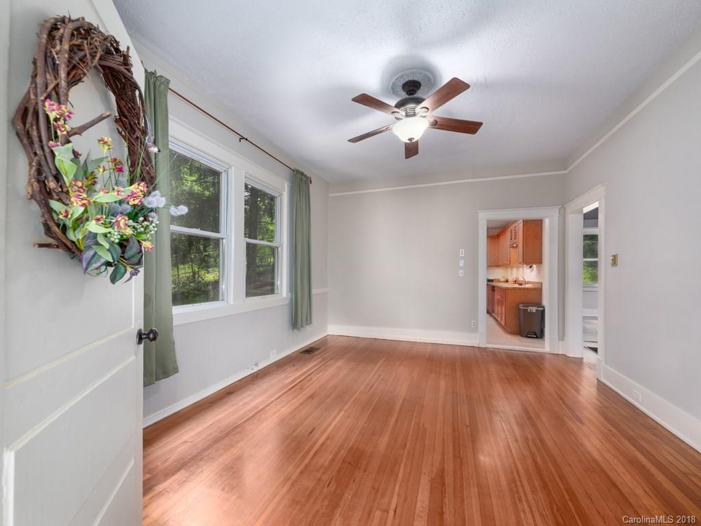 36 Sayles Road Asheville, NC 28803 - Photo 6 of 26 a view of an empty room with wooden floor and a window