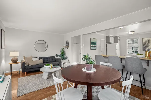 a view of a dining room with furniture and wooden floor