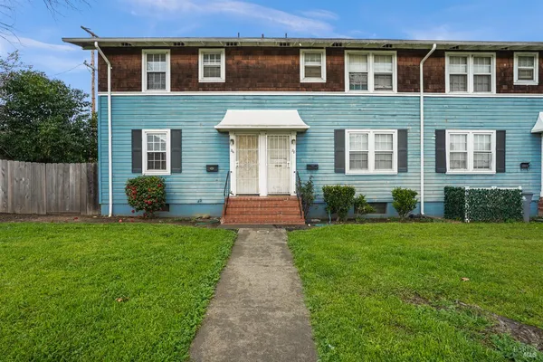 a view of a house with a yard and plants