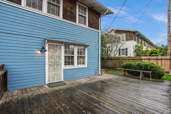 a view of a house with wooden deck