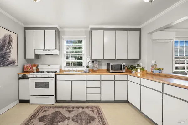 a kitchen with stainless steel appliances granite countertop a sink and cabinets