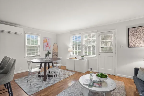 a dining room with furniture a rug and wooden floor