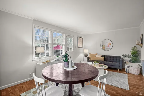 a living room with furniture a clock and a window