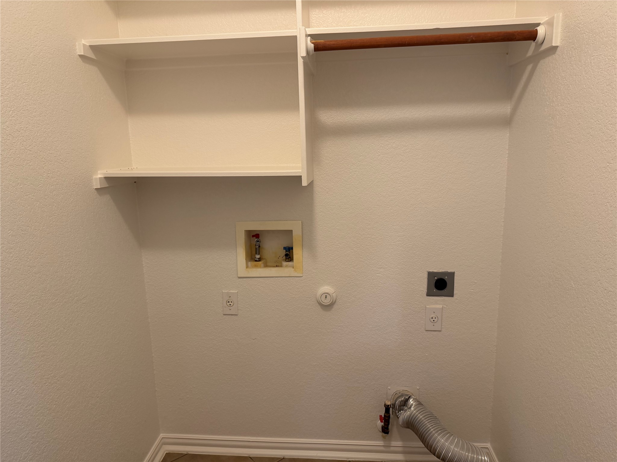 3021 Grand Mission Way Pflugerville, TX 78660 - Photo 17 of 31 A well-appointed laundry space provides convenient hookups for appliances and useful shelving.