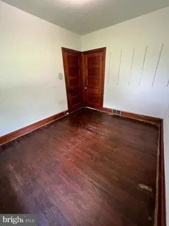 an empty room with wooden floor