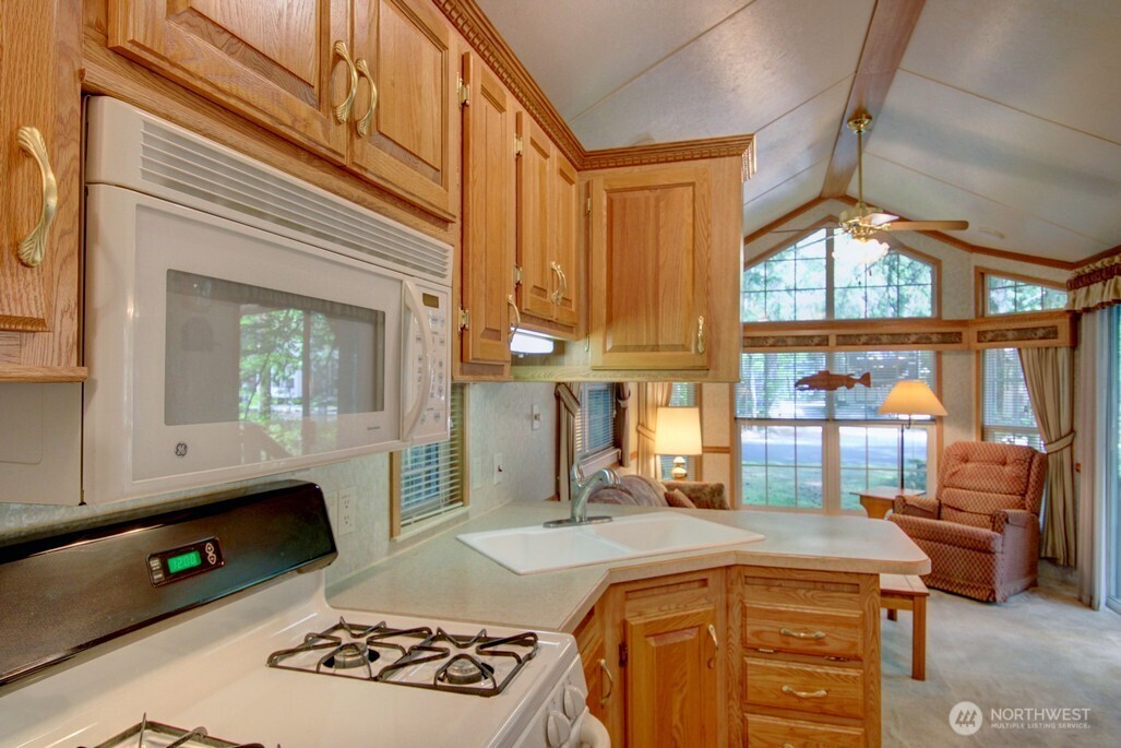 134 Drial Loop Maple Falls, WA 98266 - Photo 7 of 36 a kitchen with stainless steel appliances granite countertop a stove a sink and a microwave