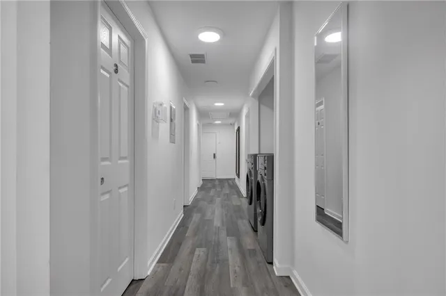 a view of a hallway with wooden floor