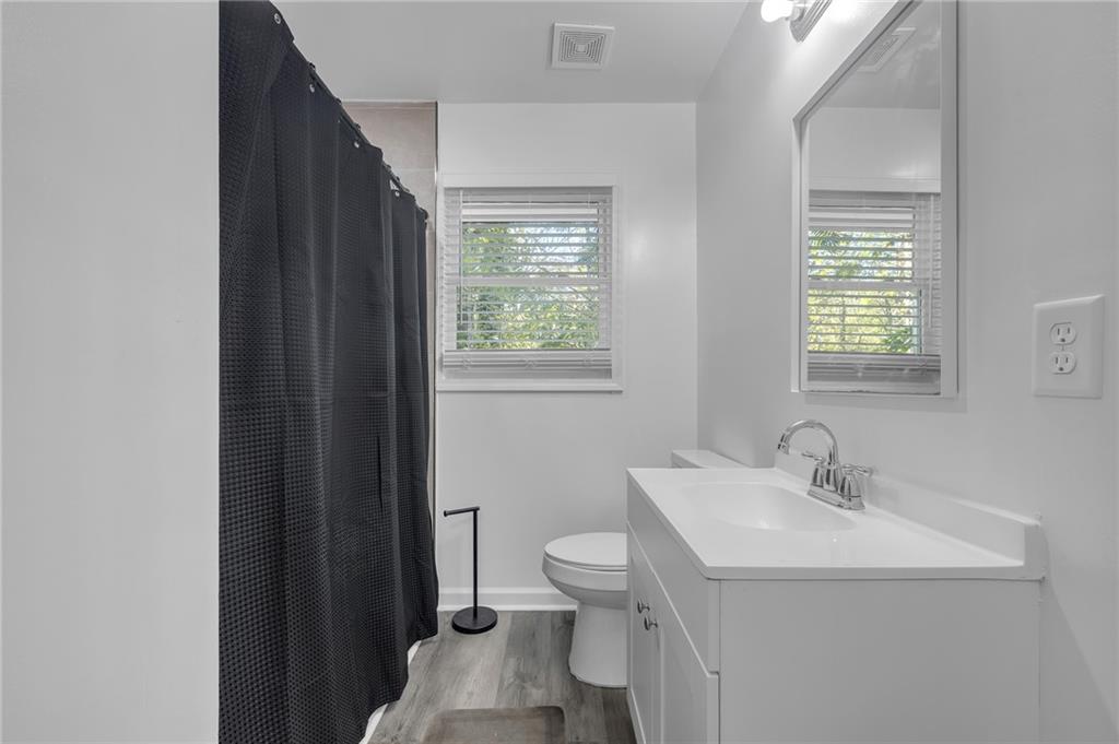 344 East Rhinehill Road Southeast Atlanta, GA 30315 - Photo 12 of 29 a bathroom with a sink toilet and a mirror
