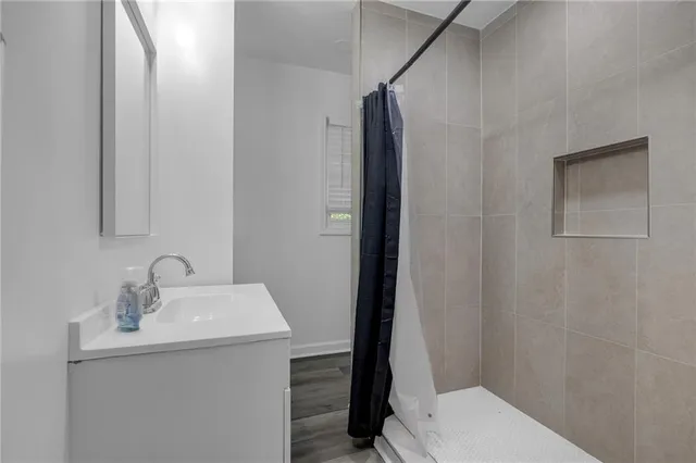 a bathroom with a sink a toilet and shower