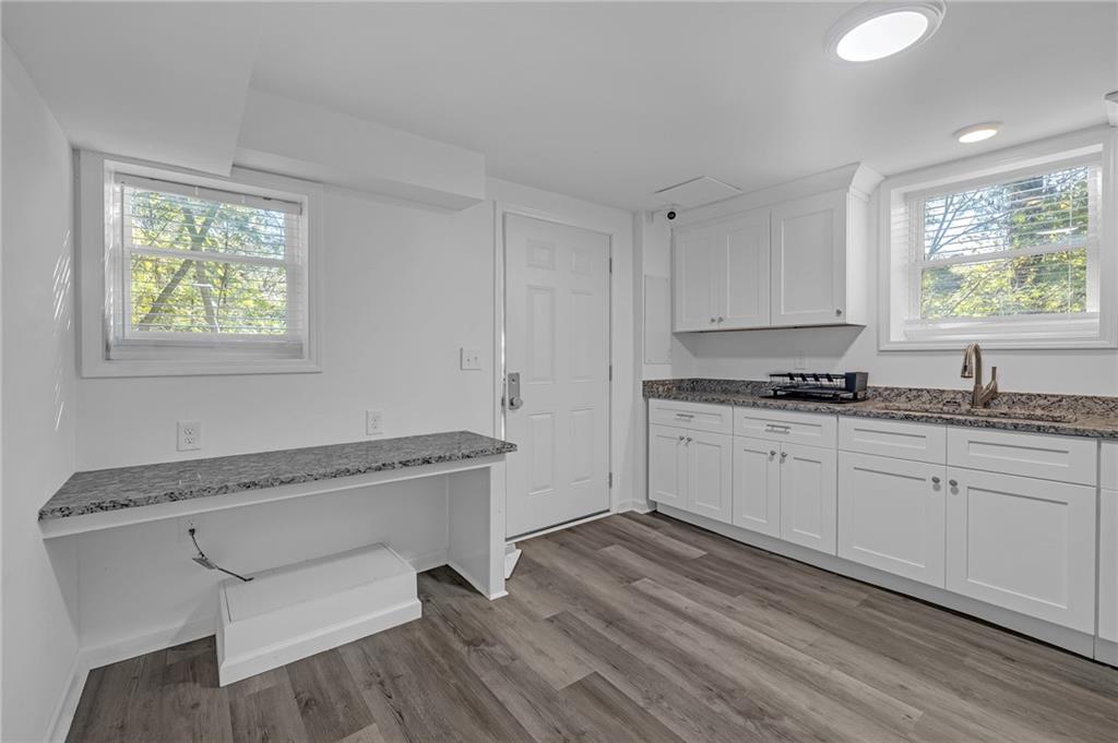344 East Rhinehill Road Southeast Atlanta, GA 30315 - Photo 16 of 29 a kitchen with granite countertop white cabinets and wooden floor