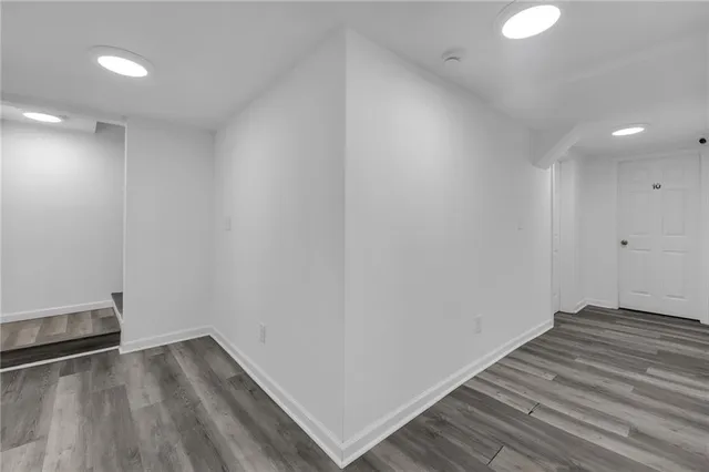 a view of wooden floor and windows in a room