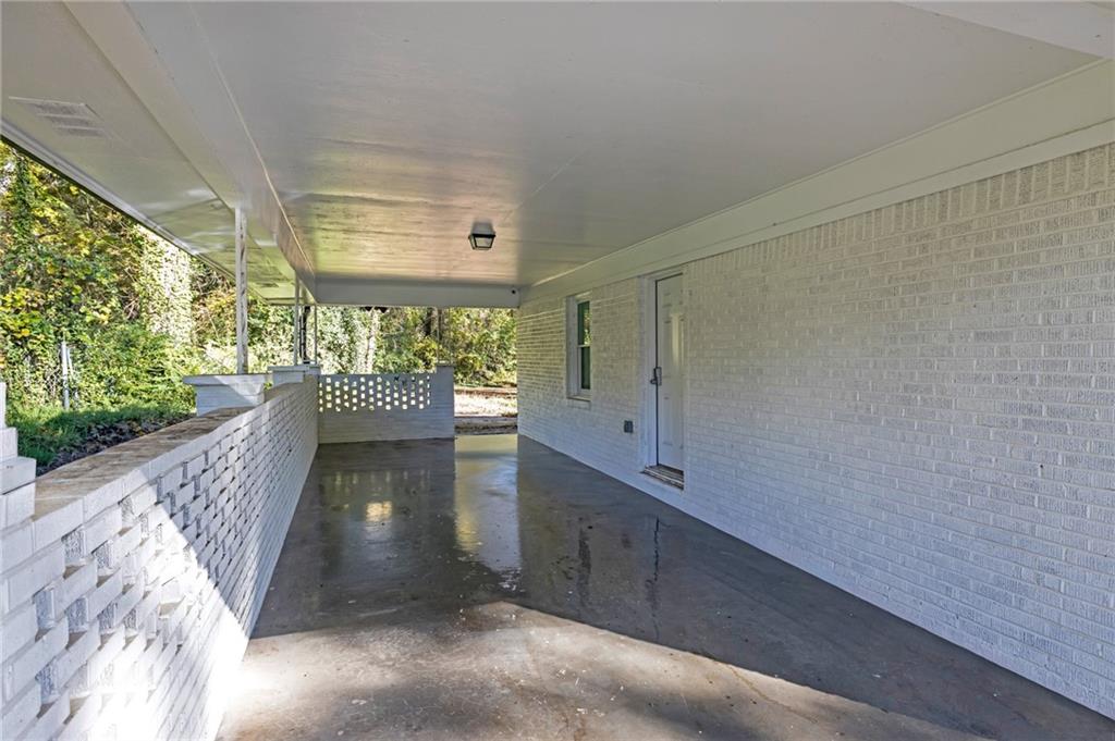 344 East Rhinehill Road Southeast Atlanta, GA 30315 - Photo 4 of 29 a view of a hallway with wooden floor and a fireplace