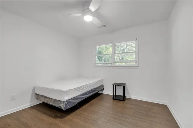 a spacious bedroom with a bed and a window