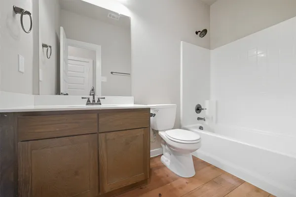 a bathroom with a sink toilet and a mirror