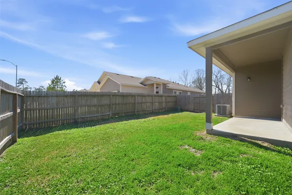 a view of a backyard with a garden and deck