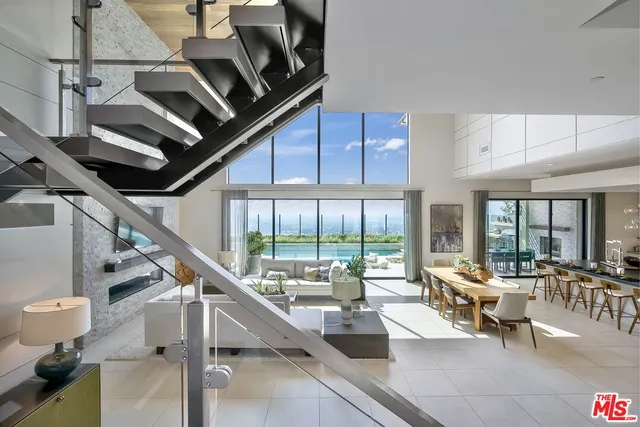 a spacious bedroom with a bed and large glass window