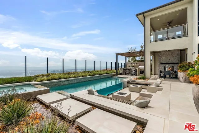 a view of a patio with swimming pool table and chairs